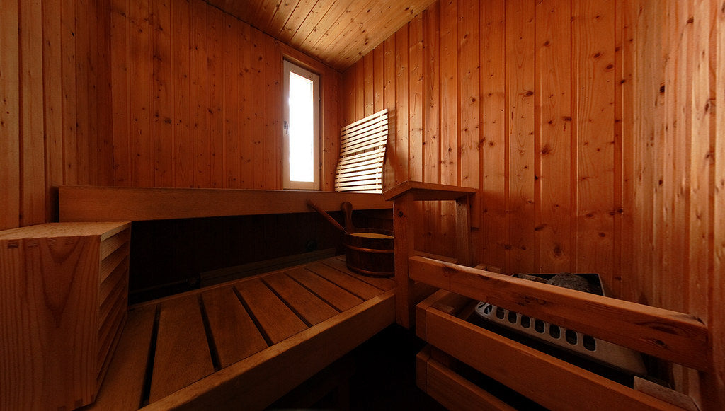Traditional Finnish sauna interior with wooden benches, sauna safety tips