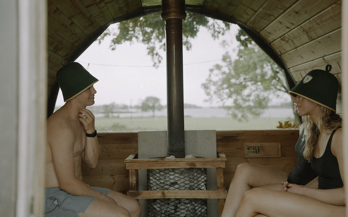 Three people in a wood-fired barrel sauna, can sauna replace exercise
