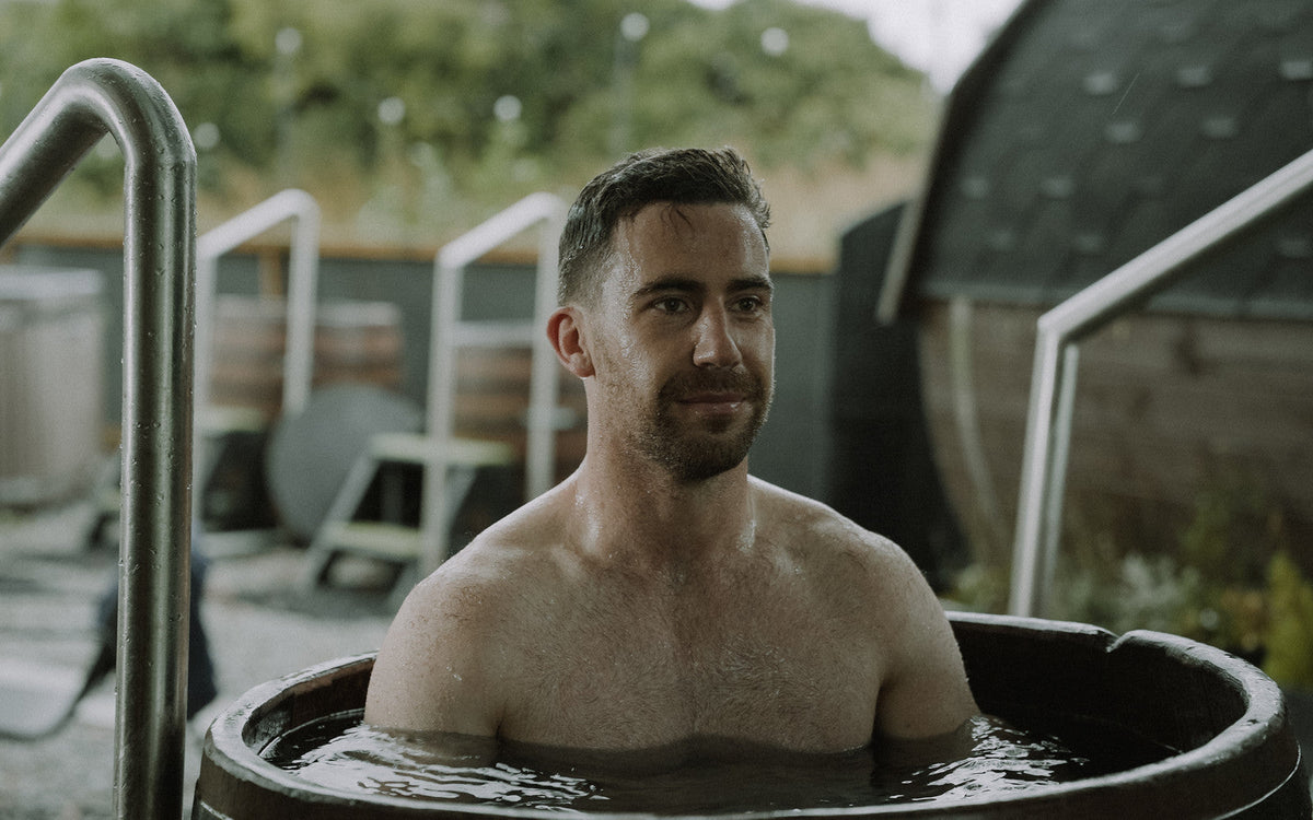 Athlete in a cold plunge barrel after the sauna, contrast therapy protocol
