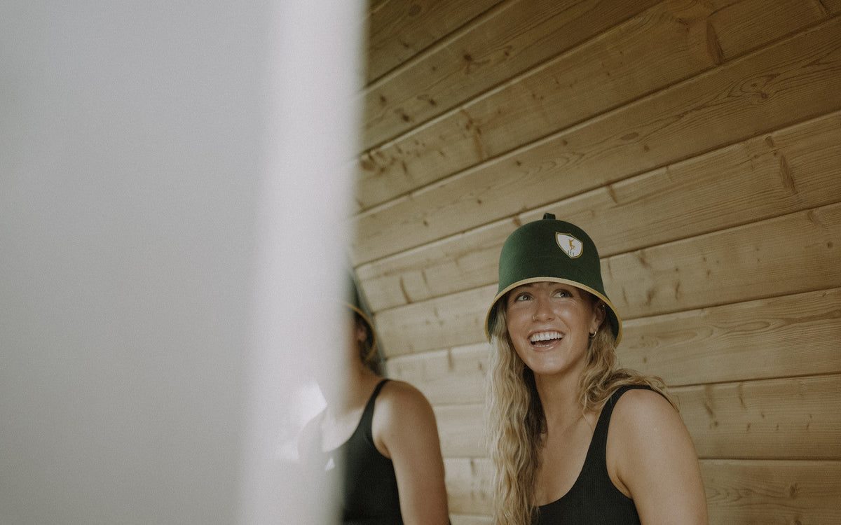 Athlete with long hair wearing the Rí Sauna Crown, does sauna damage hair