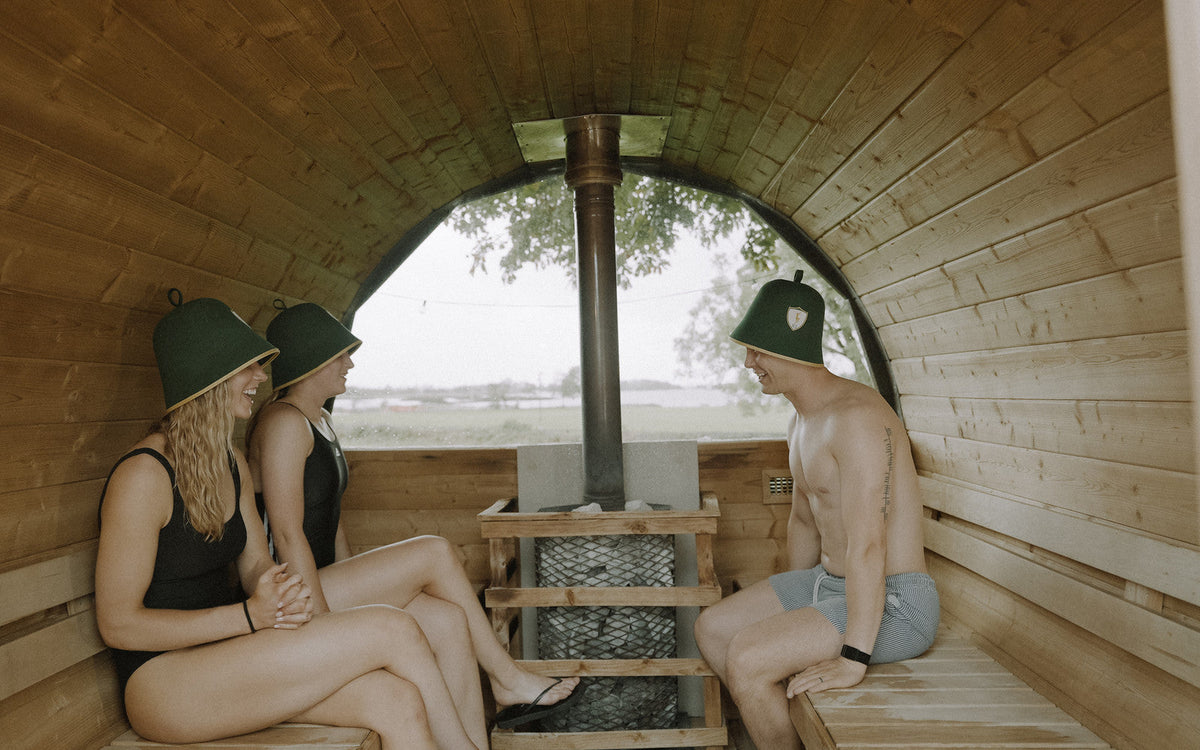 Three athletes in a barrel sauna at Loch Rí, does sauna help with weight loss