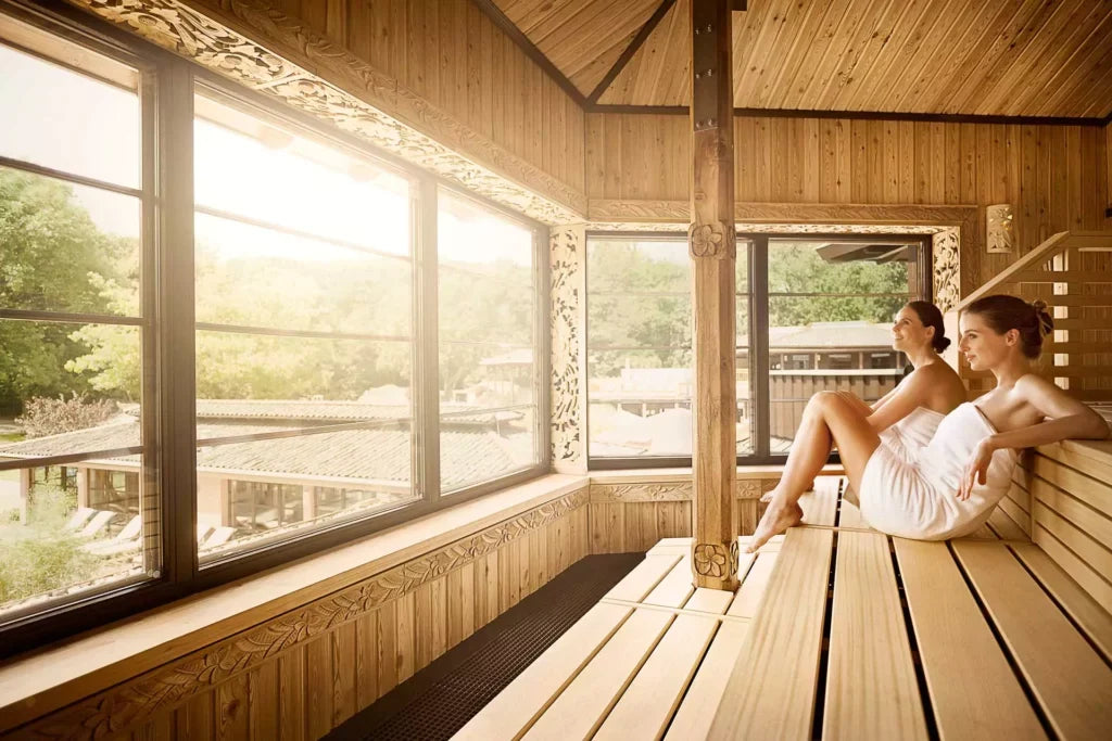 Couple relaxing in panoramic sauna, how often should you use a sauna