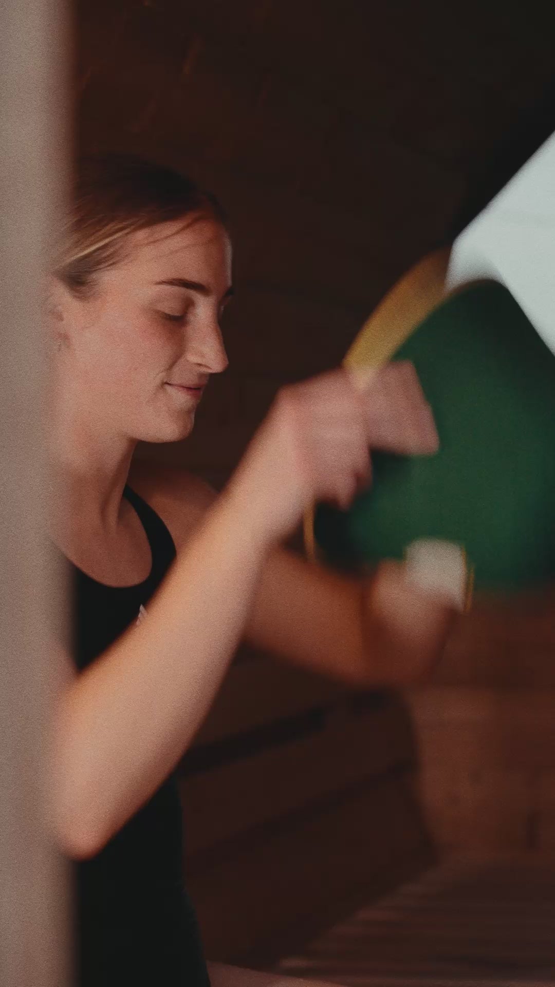 Athlete putting on the Rí Sauna Crown in a barrel sauna
