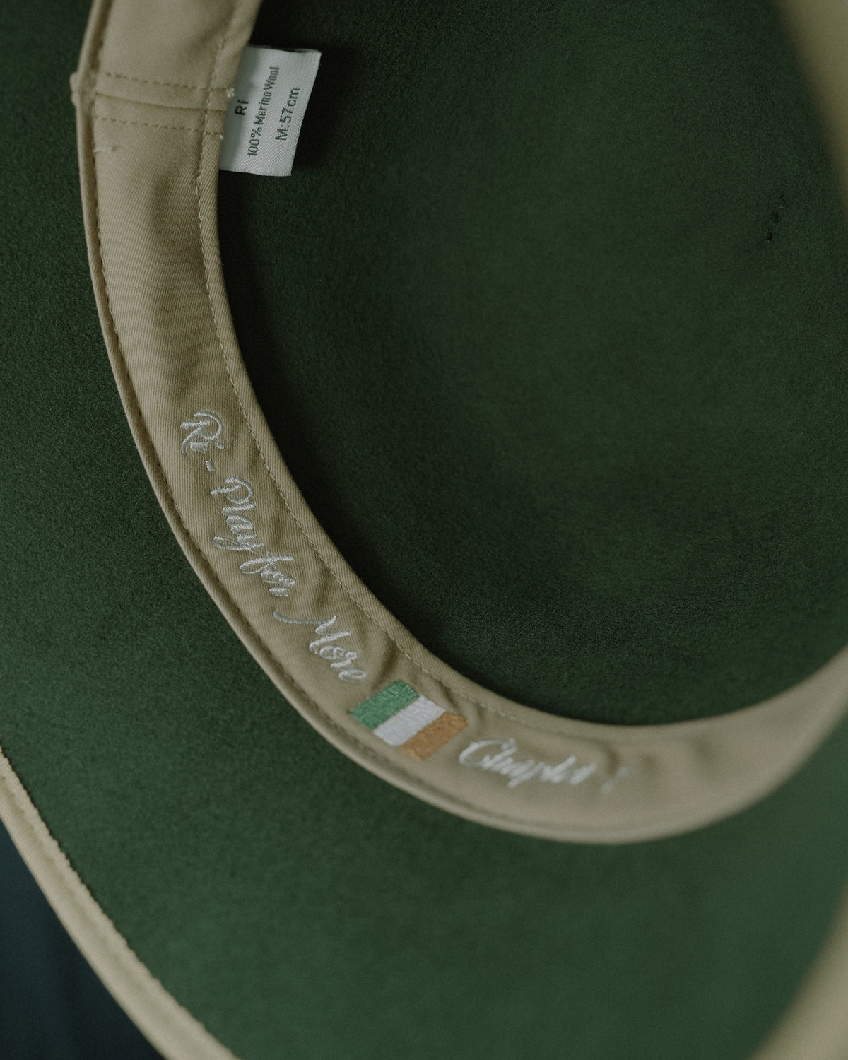 Inside band of the Rí Sauna Crown with the Play for More embroidery, Irish tricolour and Chapter 1
